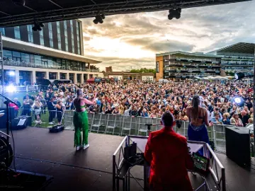 A view from the music stage across the crowd and buildings at Doncaster Races 