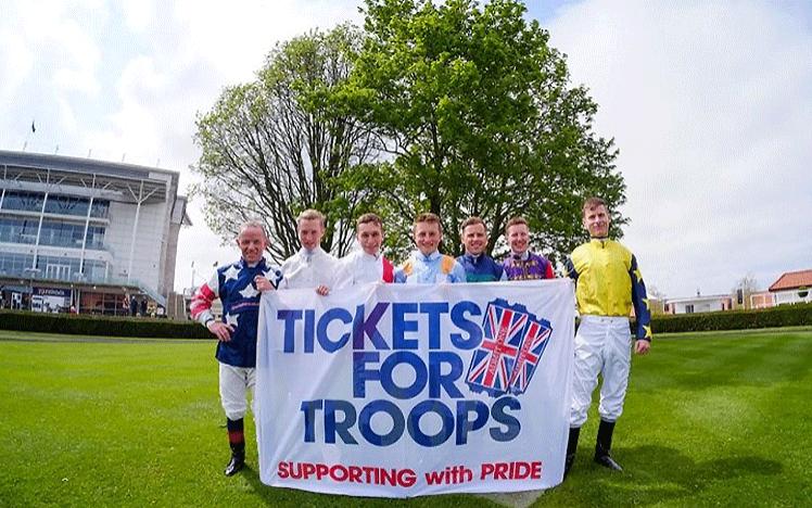 Jockeys Stand with the Tickets For Troops Banner