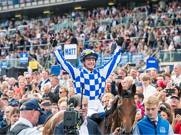 Saffie Osborne celebrating after winning the St Leger Stakes on Highwayman
