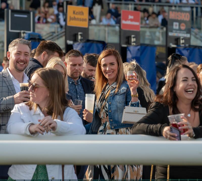 Race goers at Doncaster in front of the bookmakers