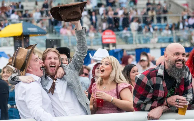 Racegoers watching from the trackside at Doncaster cheer at the end of a race