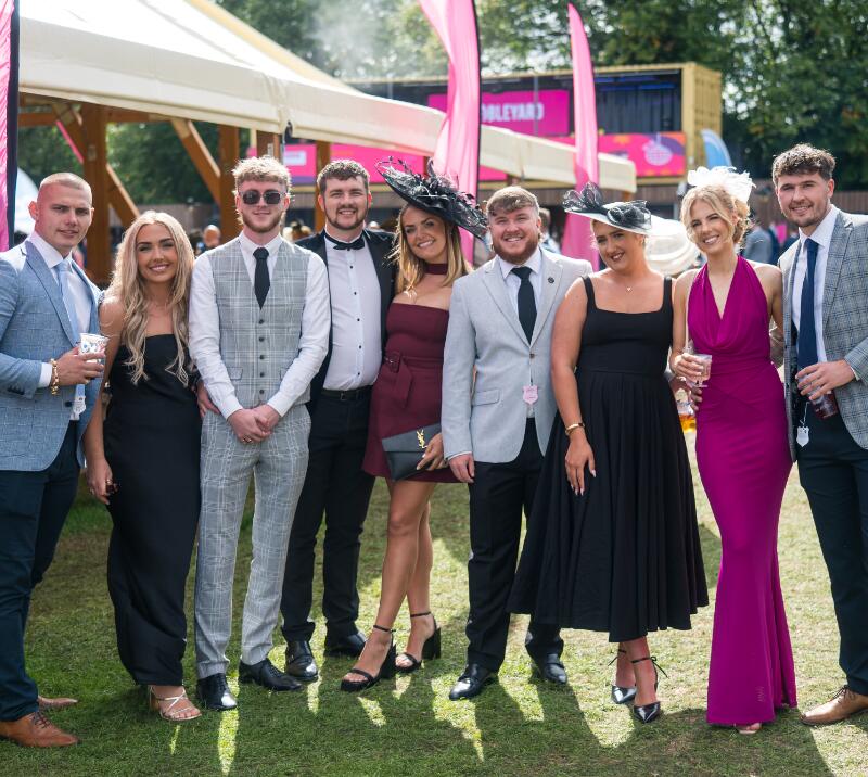 A group of men and women dressed up at Doncaster Racecourse 