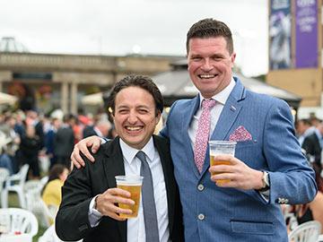 Two gentlemen smiling for a photo at Doncaster Racecourse.