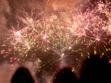 shadows of people watching a firework display 