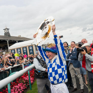 Saffie Osborne celebrating with the St Leger trophy
