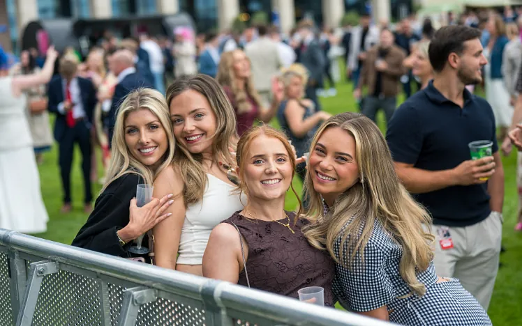Group of young girls smiling at Doncaster Racecourse