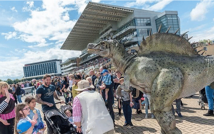 A family is introduced to a Dinosour statue