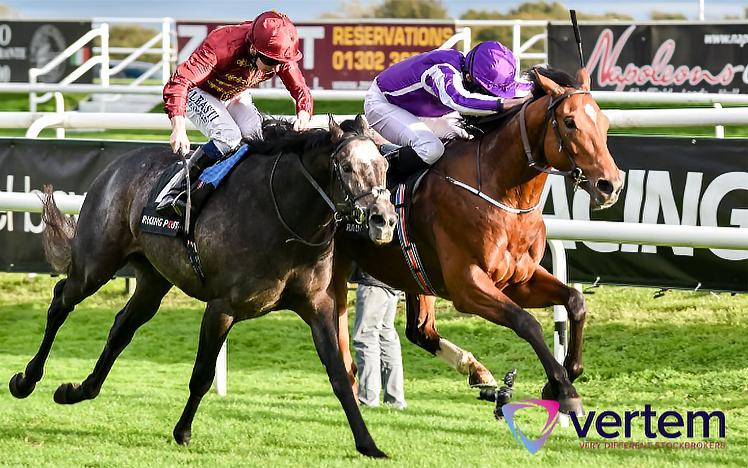 Two jockeys race their horses against each other