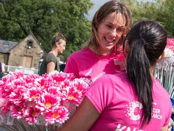 To racegoers wearing brightly coloured t-shirts with charity logos on them.