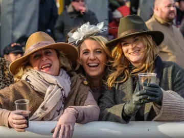 Three women enjoying the races during autumn 