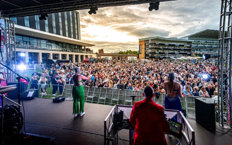 A view from the music stage across the crowd and buildings at Doncaster Races 