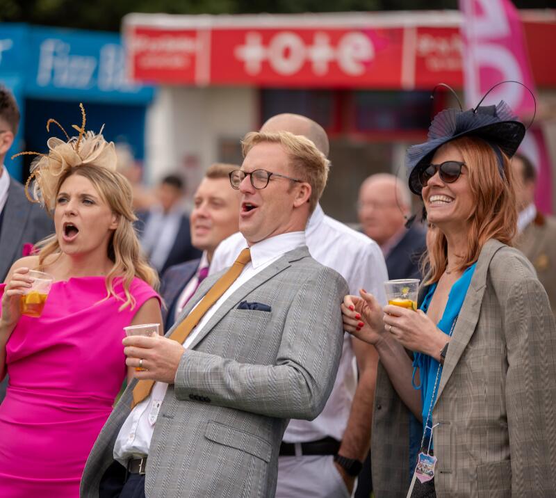 A group of race goers at Doncaster Races enjoying the race.