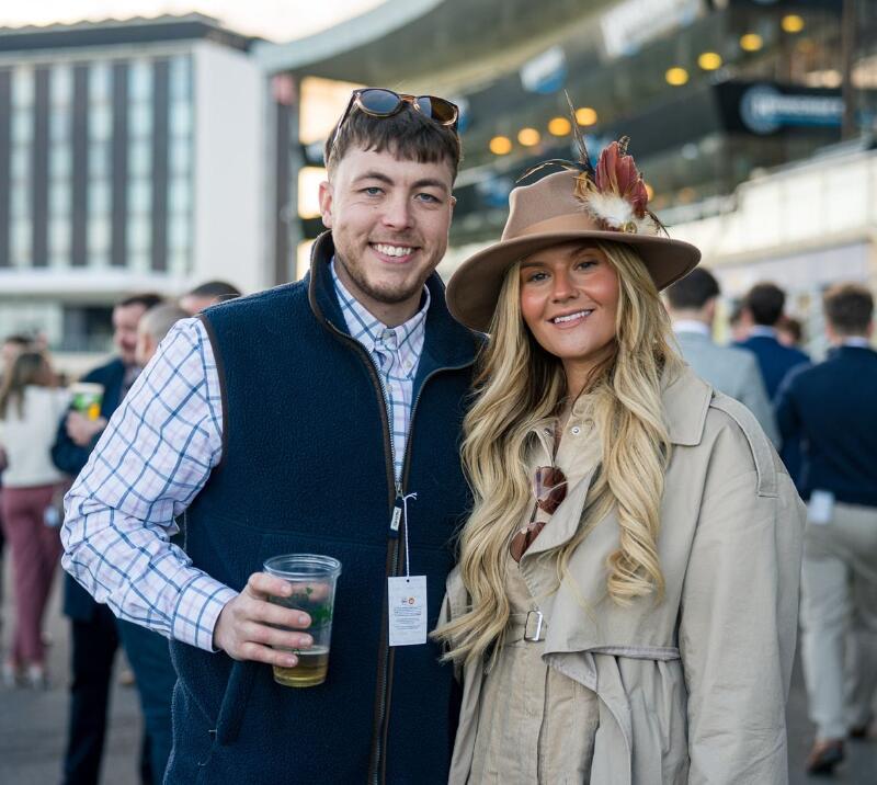 A couple posing in front of the stands at Doncaster Races