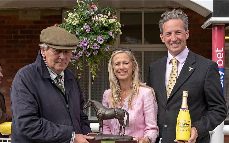 Robin O’Ryan (left) receiving the leading trainer trophy on behalf of Richard Fahey, from Clare and Mark Oglesby of Goldsboro