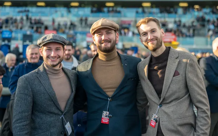 Three men stood at the races