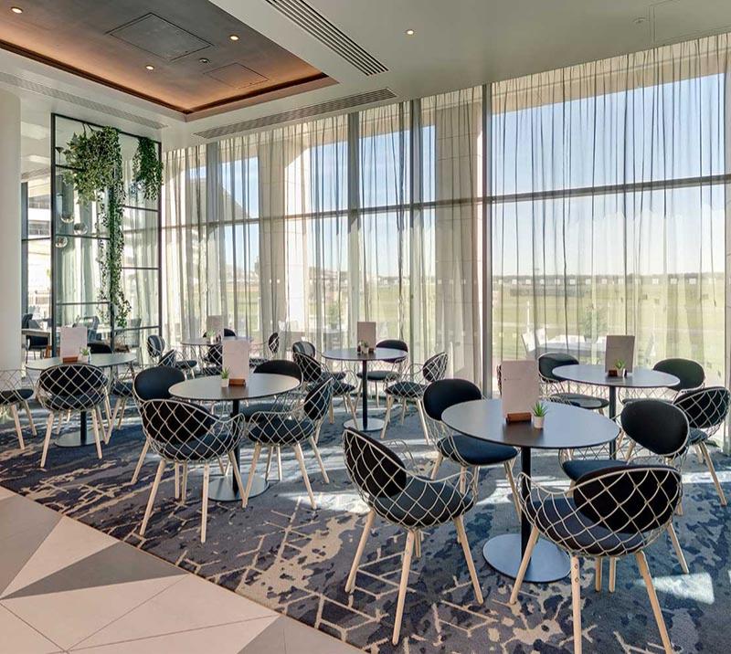 Tables and chairs set up inside the restaurant at the Hilton hotel at Doncaster Racecourse.