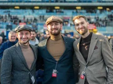 Three men stood at the races 