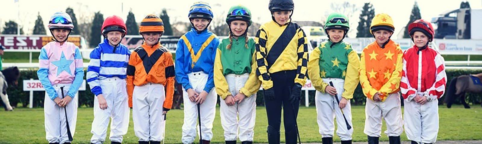 Young jockeys lined up ready for racing at Doncaster Racecourse